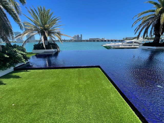 On-Time Turf team demonstrating the advantages of artificial grass installation in Coconut Grove, offering a lush, green, and low-maintenance lawn.