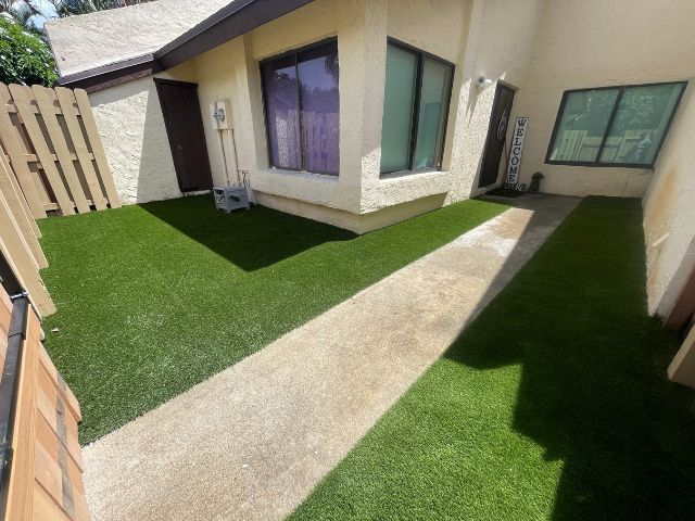 On-Time Turf professionals installing artificial grass in Fort Lauderdale, FL, showcasing the eco-friendly and low-maintenance benefits of synthetic turf.