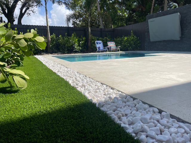 On-Time Turf experts working on artificial grass installation in Fort Lauderdale, FL, highlighting the durability and professional finish of their service. Artificial Grass Installation near me.